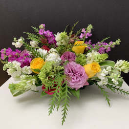 Mixed bouquet with pink, yellow, and white flowers on a table