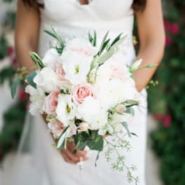 Bride holding a white and blush bouquet