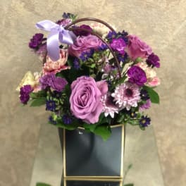 Purple and pink flower basket with a lavender ribbon