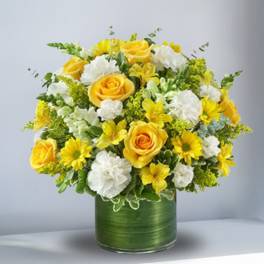 Yellow roses and white flowers arranged in a green vase