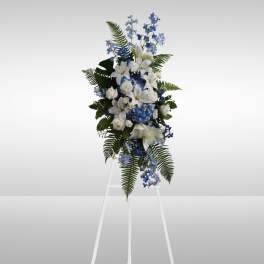 Tall blue and white floral standing spray on an easel