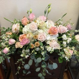 Large pastel floral arrangement with roses and white blooms