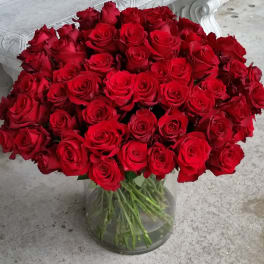 Large bouquet of red roses in a clear glass vase