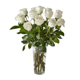 White roses arranged in a clear glass vase