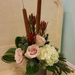 Pink roses and white hydrangea in a vase with tall brown cattails