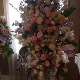Tall pastel floral standing arrangement with roses and orchids