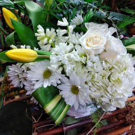 White bouquet with roses, daisies, and yellow tulips