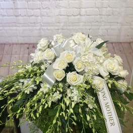 White rose and lily arrangement with a satin ribbon and mother tribute tag
