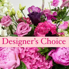 Pink and purple mixed flower bouquet with a Designer's Choice banner