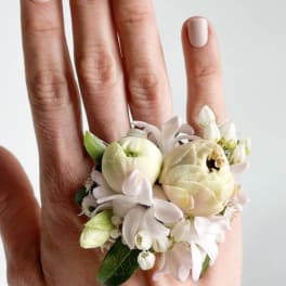 Small floral ring with cream and white blooms on a hand