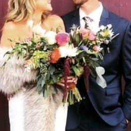Bride and groom holding a colorful wedding bouquet