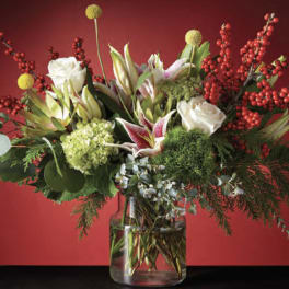 Mixed bouquet of white roses and lilies in a glass vase