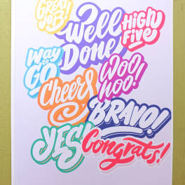 Colorful congratulations greeting card with bold hand-lettered phrases on a white background