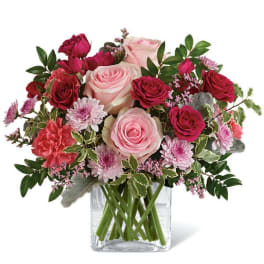 Pink and red rose bouquet in a clear glass vase