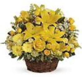 Yellow flower arrangement in a wicker basket