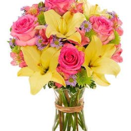 Pink roses and yellow lilies in a glass vase