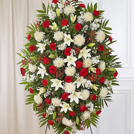 Standing floral spray with red roses, white lilies, and white chrysanthemums