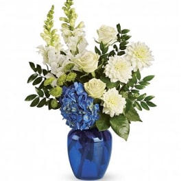 White flowers and blue hydrangea in a cobalt vase