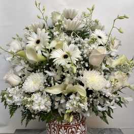 White floral arrangement in a decorative terracotta vase
