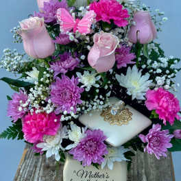 Pink roses, chrysanthemums, and carnations in a decorative vase