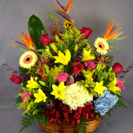 Colorful tropical flower basket with lilies, roses, and gerbera daisies