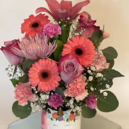 Pink and coral mixed bouquet in a unicorn mug vase