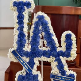 Blue and white floral tribute shaped like the number 14 on a stand