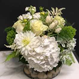 White floral arrangement in a low glass bowl