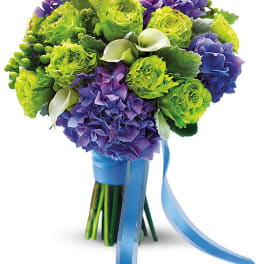 Bouquet of green and purple flowers tied with a blue ribbon