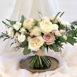 Cream and blush rose bouquet with greenery on a tray