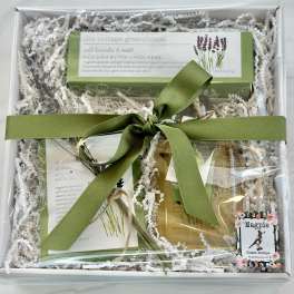 Gift box with lavender bath products tied with a green ribbon