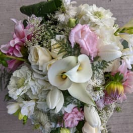 Bouquet of white calla lilies, roses, and pink flowers