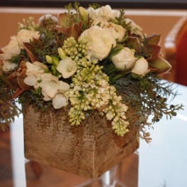 White floral arrangement in a rustic wooden box