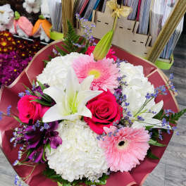 Bouquet of pink roses, white lilies, and pink gerbera daisies