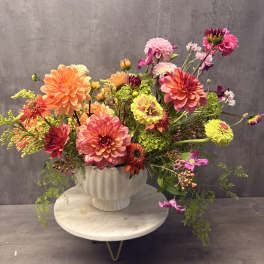 Colorful mixed bouquet of dahlias in a white vase