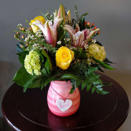 Pink vase arrangement with lilies, roses, and hydrangeas