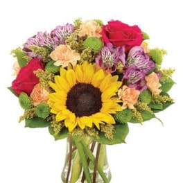 Bouquet with a sunflower, roses, and alstroemeria in a glass vase