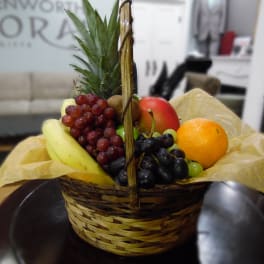 Basket of assorted fruit with a pineapple centerpiece