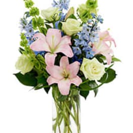 Pink lilies and white roses in a clear glass vase