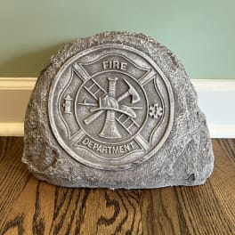 Decorative stone plaque with a fire department emblem