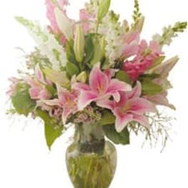Pink lilies arranged in a glass vase