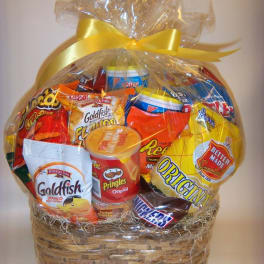 Basket of assorted snack foods wrapped in clear cellophane with a yellow bow