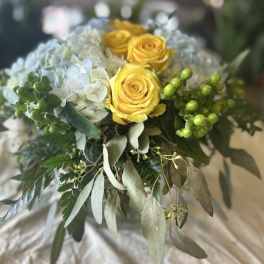 Bouquet of yellow roses and white hydrangea with greenery