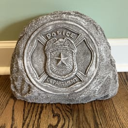 Stone police department plaque on a wooden floor