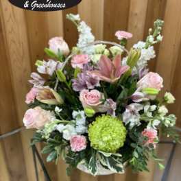 Basket arrangement of pink and white flowers with a green chrysanthemum