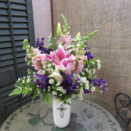 Pink lilies and purple flowers in a white vase