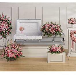 Pink floral funeral casket spray with matching standing arrangements and wreaths