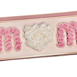 Pink and white roses arranged in a framed heart design with the word MOM.