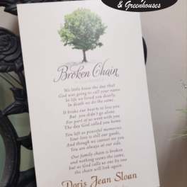 Memorial card with a tree graphic and poem on a black wrought-iron stand