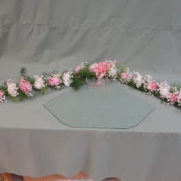 Long pink and white floral garland with a ribbon bow